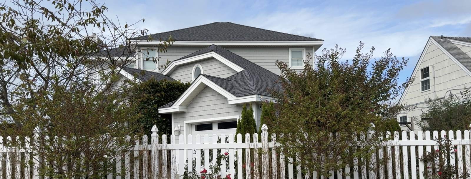 Finished gray architectural shingle roof on a coastal home